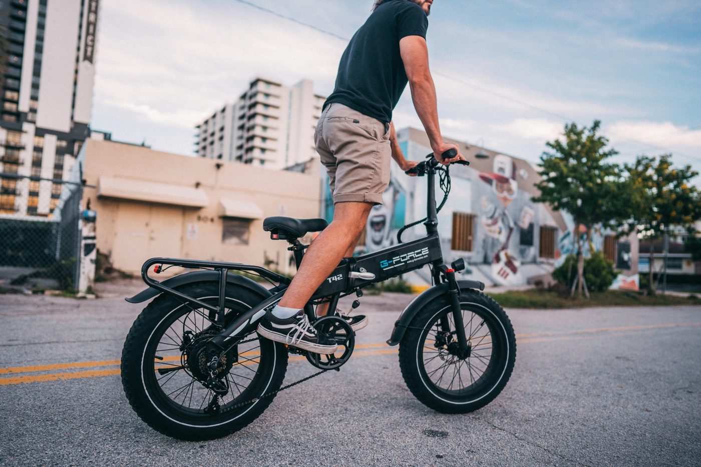 Side profile of a compact folding fat-tire e-bike in an urban setting